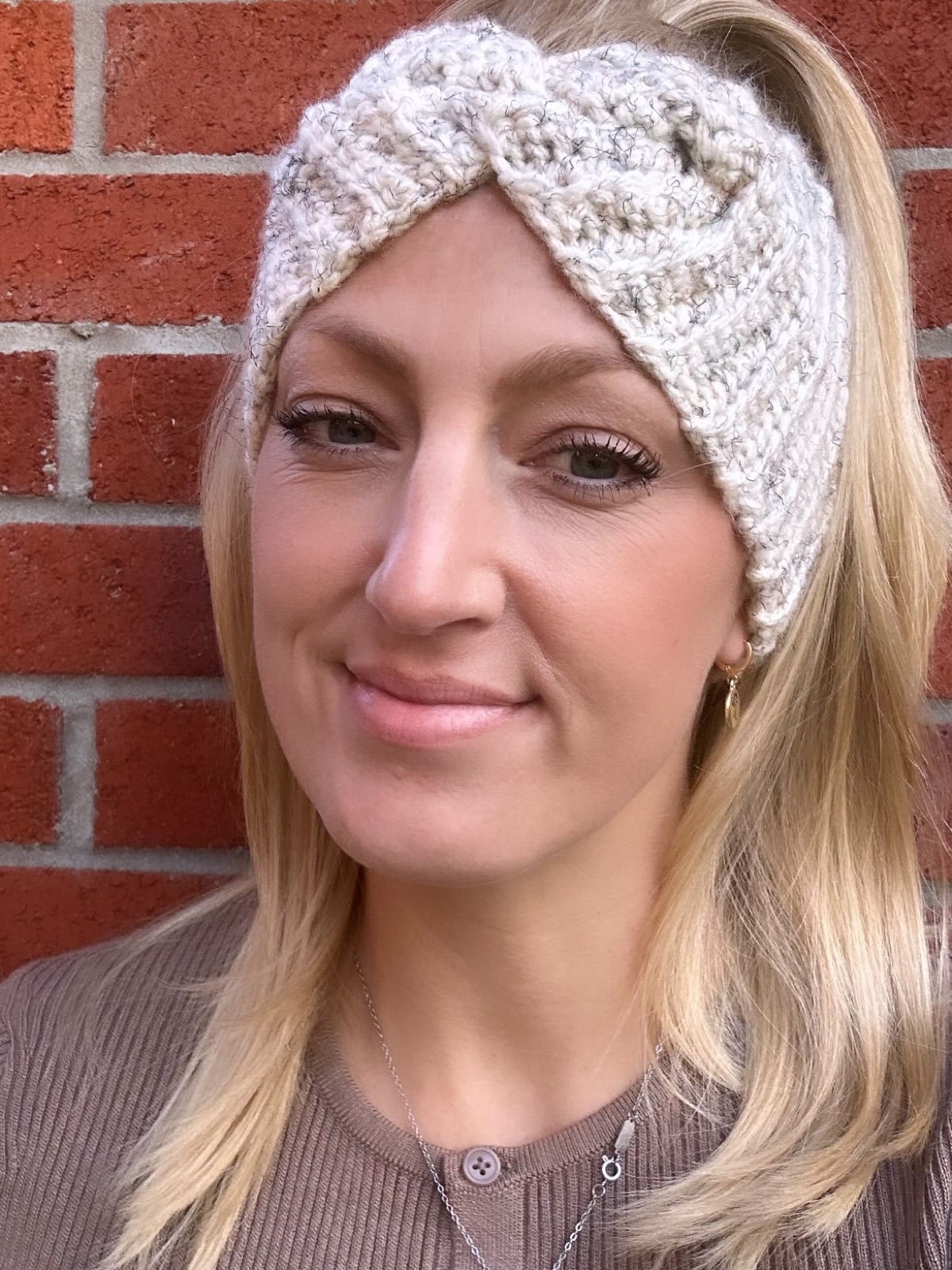 Rachael wearing a crocheted ear warmer headband she made